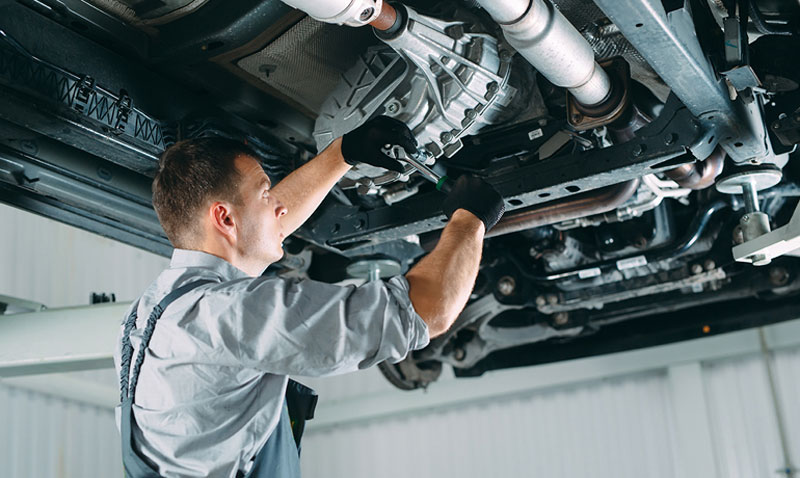 Mechanic checking problems under the engine